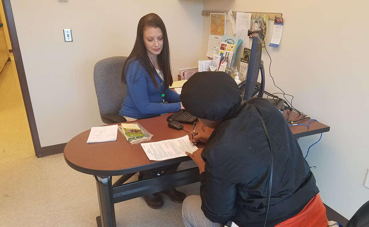 Dakota County Birth to Age Eight Collaborative Initiative staff member helps county resident share her family's information with school districts.