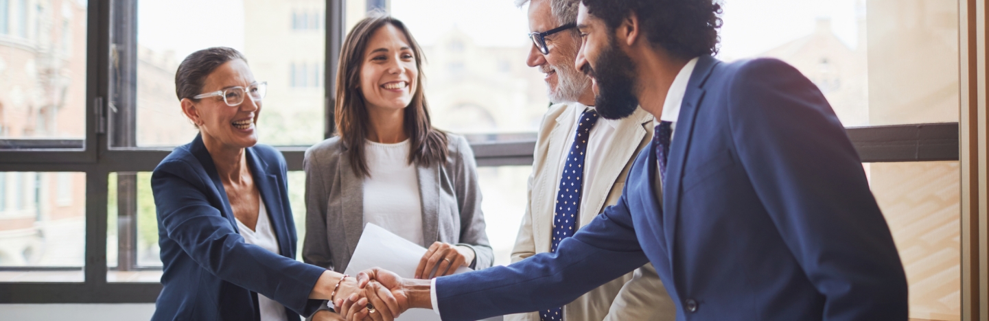 A group of business people shake hands