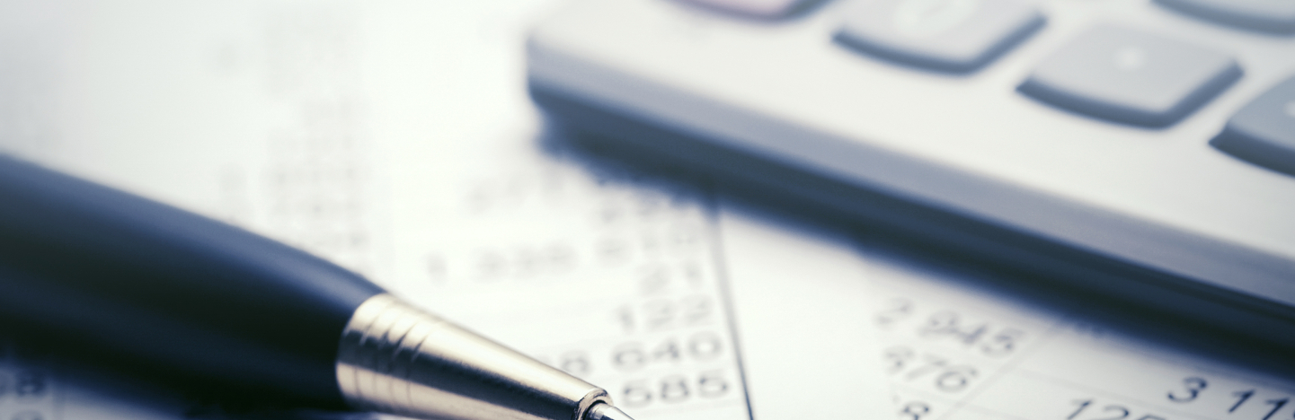 A pen rests near a calculator