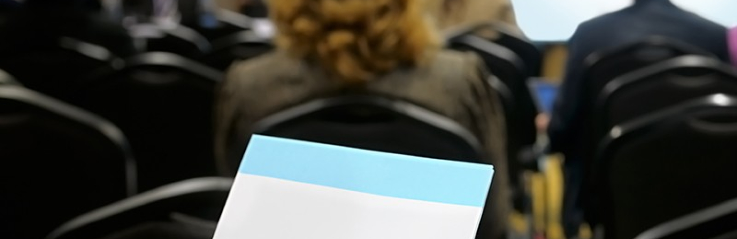 A person takes notes in a meeting
