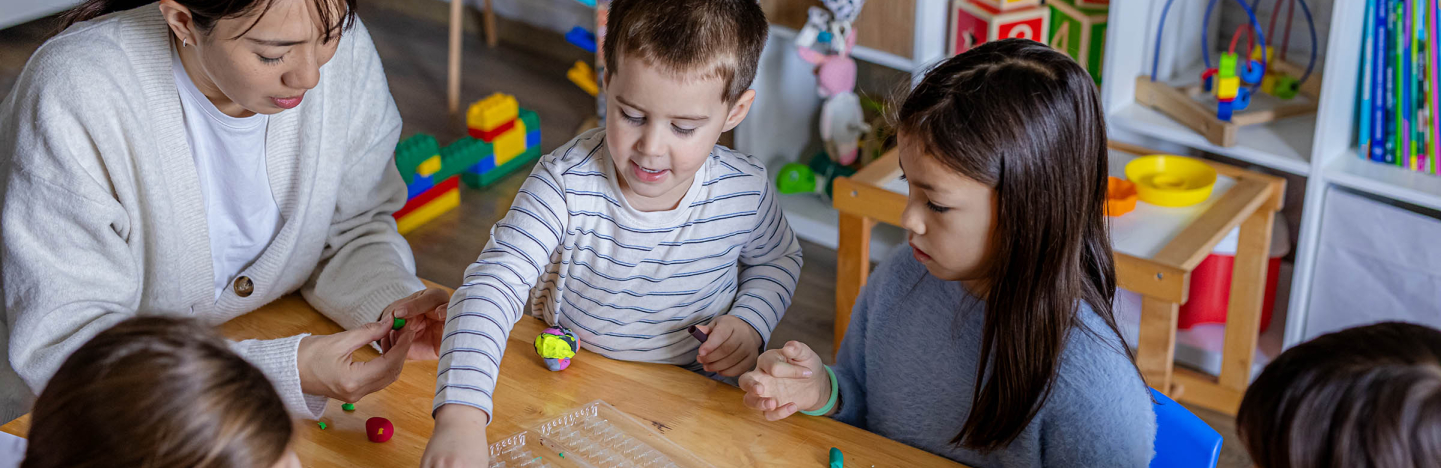 Children playing with a teacher
