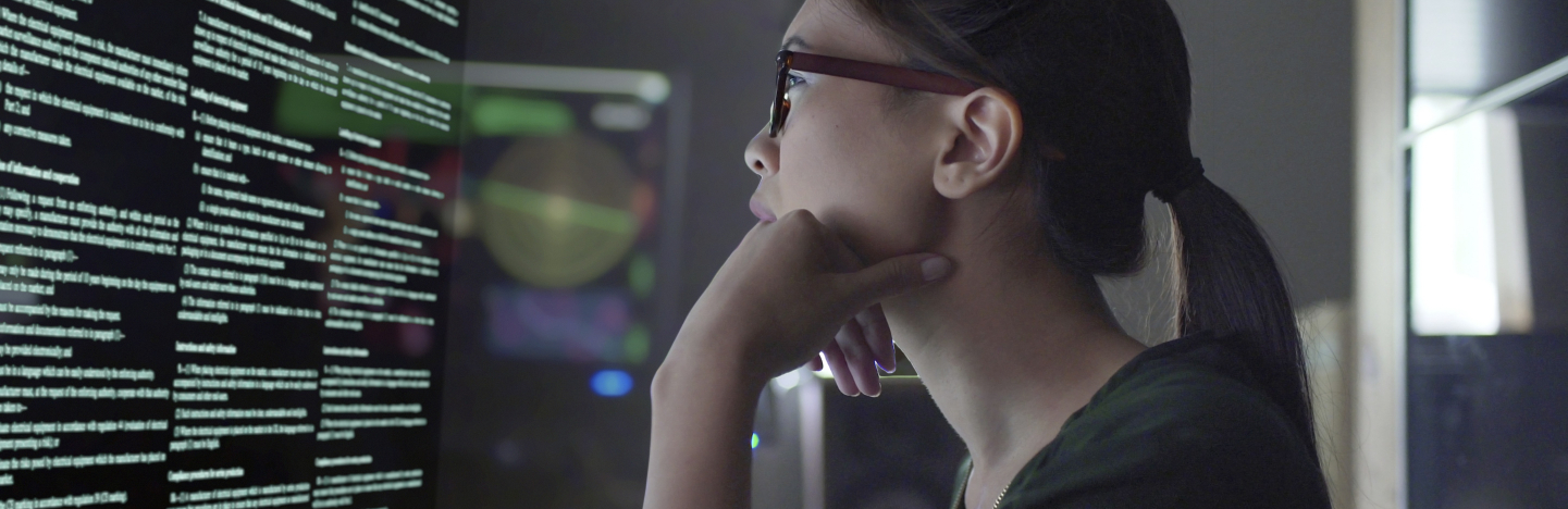 a woman reads text on the computer screen