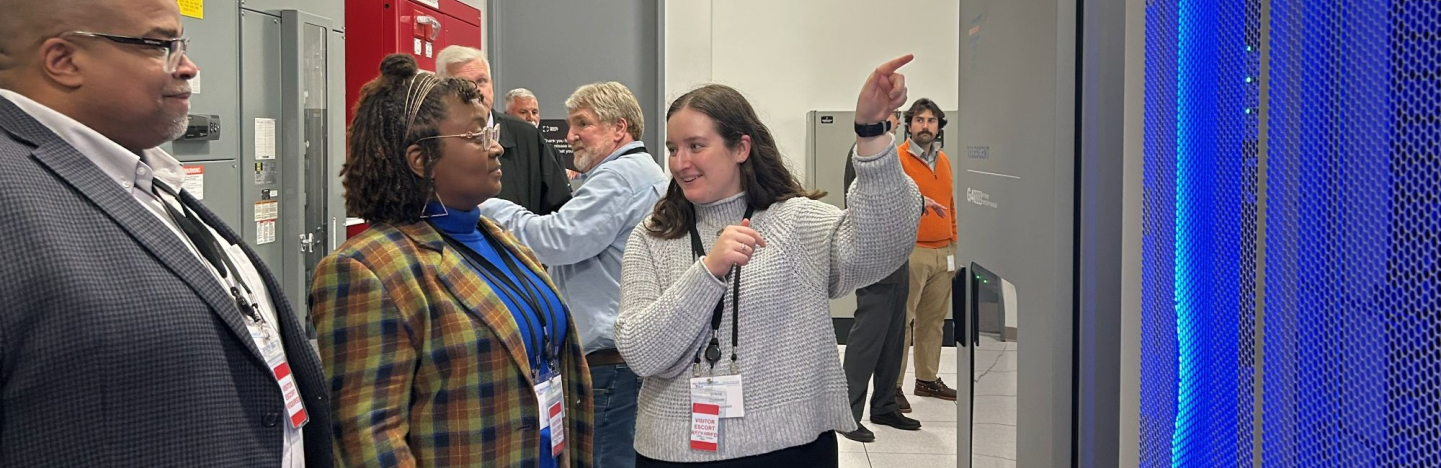 NACo Associate Legislative Director Emma Conover shows Wake County, N.C. Commissioner Shinica Thomas and her husband, Raymond, the inside of a server rack at a Digital Realty data center in Loudoun County, Va., in October 2025. Photo by Charlie Ban