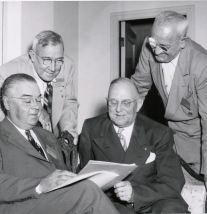 G. Claiborne Blanton, Joseph F. Hammond, Harry Bartell and Stanley Martin review the program for the 1949 National Association of County Officers Annual Conference.