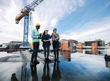 Architects and investors meeting at the construction site, on top of the residential building under construction.