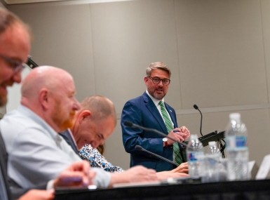 Kevin Leonard, executive director of the North Carolina Association of County Commissioners cracks a joke before state association directors get down to business. Photo by Leon Lawrence III