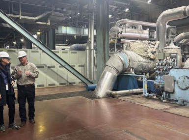 Cindy Winland, senior consultant, Interagency Working Group for Energy Communities, talks with an engineer at Naughton Power Plant in Lincoln County, Wyo.