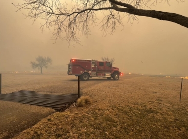 A firetruck parks in West Texas as smoke billows from wildfires. Photo courtesy of Greenville, Texas Fire-Rescue