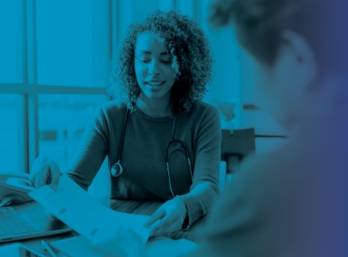 Doctor in plain clothes discussing document with patient