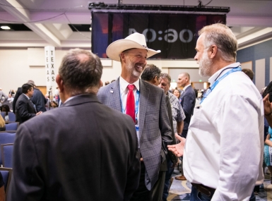 Ravalli County, Mont. Commissioner Greg Chilcott talks to colleagues before the General Session at the 2022 NACo Annual Conference. Photo by Denny Henry