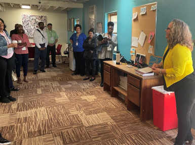 County Juvenile Justice Innovation Network Peer Exchange attendees tour the New Day Drop-In Center. (L-r): The Cumberland County, N.C. team Tiffany M. Whitfield, Nichelle Gaines, Kevin Brooks and Jason Hunter; Carmela Romero of Bernalillo County, N.M.; the Martin County, N.C. team: Emily Biggs, Tracie Smith; and Brooke Tafoya, executive director, New Day Youth & Family Services. Photo by Megan Siwek