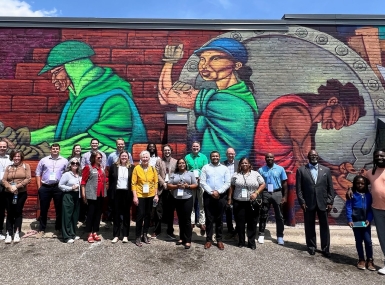 Peer exchange attendees visit a mural during a walking tour of Ramsey County, Minn.