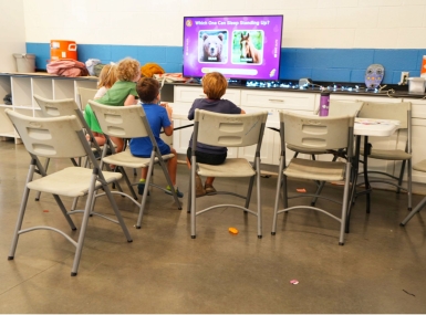 Children play an educational game in the library at the South Philadelphia Community Health and Literacy Center. Photo by Leon Lawrence III