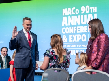 J.D. Clark takes the oath of office, administered by his daughter, Claire, at the 2025 Annual Conference. Photo by Denny Henry