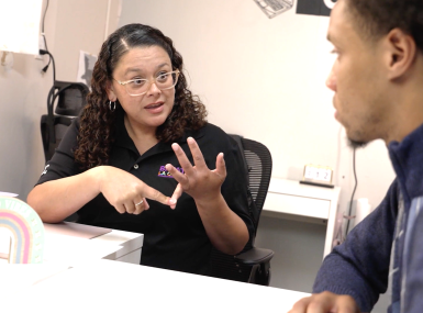 Karina Reyes, a Strength Based Community Change economic development coach, works with Elijah, a BREATHE participant. Photo courtesy of Los Angeles County