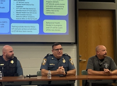 Officers from the Henrico County Police Division’s community services department discuss how they collaborate to help keep mentally ill people from continual jail visits. Photo by Meredith Moran 