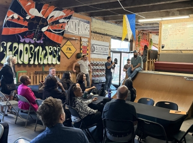 Taylor Woodruff, executive director of Youth Serving Agencies Network member organization Alchemy Skateboarding, outlines his organization's community-based programming for court-involved youth centered around skateboarding and manufacturing skills. Photo by Bryce Wilkom