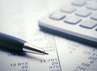 A pen rests near a calculator