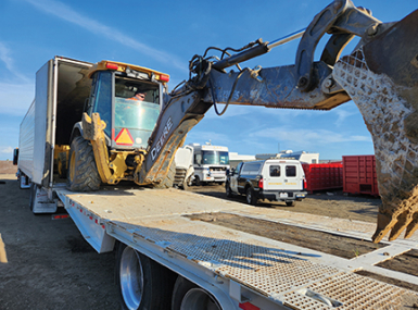 A stolen backhoe being unloaded in March 2024 from a semitruck, recovered by law enforcement in Tulare County, Calif. Photo courtesy of the Tulare County Sheriff’s Office