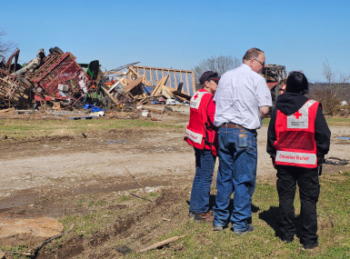 Okmulgee County, Okla. Emergency Manager Jeff Moore surveys tornado damage with Red Cross volunteers. Photo courtesy of the Red Cross