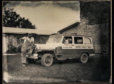 Curator Nathan Carroll poses with the Carter County Museum’s field vehicle, purchased in the 1960s.