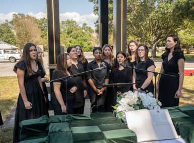 Choir members sing at a ceremony honoring the county's indigent who went unclaimed after their deaths.