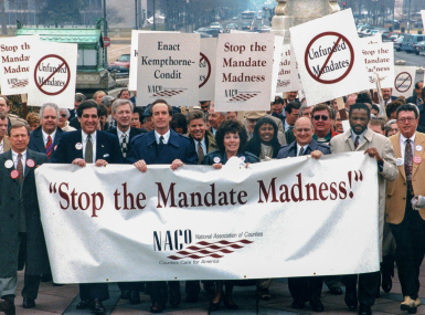 Sen. Dirk Kempthorne (front row, fifth from left) joins a march to the U.S. Capitol during the 1994 NACo Legislation Conference. Photo by David Hathcox