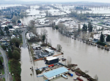 A powerful atmospheric river causes widespread flooding across Washington state in December 2025, damaging homes, businesses and major roadways.
