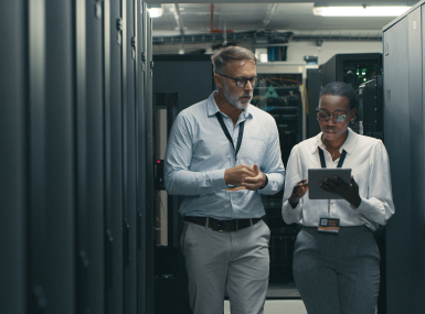 Shot of a man and woman using a digital tablet while working in a data center