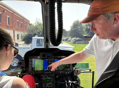 Aviation Supervisor Jeff Fletcher shows Wayne County, Mich. Commissioner Melissa Daub how the New Orleans Mosquito, Termite and Rodent Control Board's helicopter sprays for both mosquito adults and larvae.  Photo by Charlie Ban