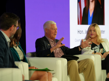 Mason County, W.Va. Commissioner Rick Handley describes the extent to which his Legislative preempted local control on data centers during an educational summit July 18. Heather Coil, of the Data Center Coalition, is to his left. Photo by Charlie Ban