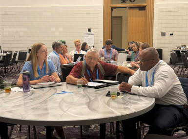 Courtney Biere of the Iowa State Association of Counties, Mills County, Iowa Supervisor Richard Crouch and Wake County, N.C. Deputy County Manager Duane Holder discuss opioid settlements. Photo by Cameron Leonard