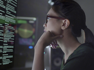 a woman reads text on the computer screen