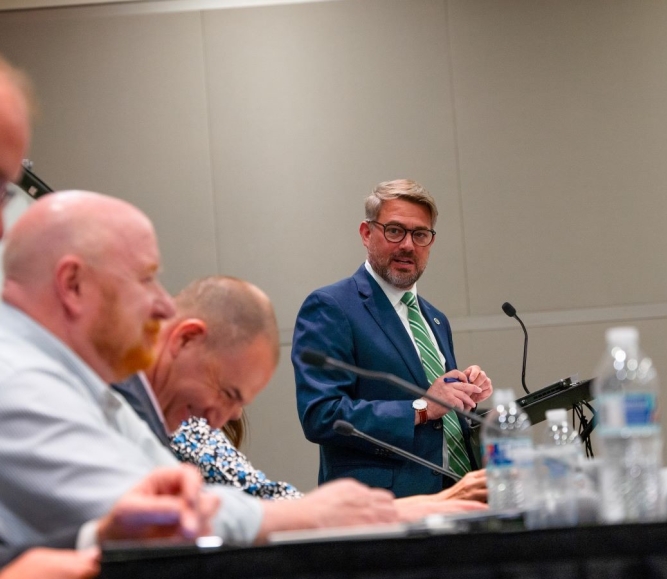 Kevin Leonard, executive director of the North Carolina Association of County Commissioners cracks a joke before state association directors get down to business. Photo by Leon Lawrence III