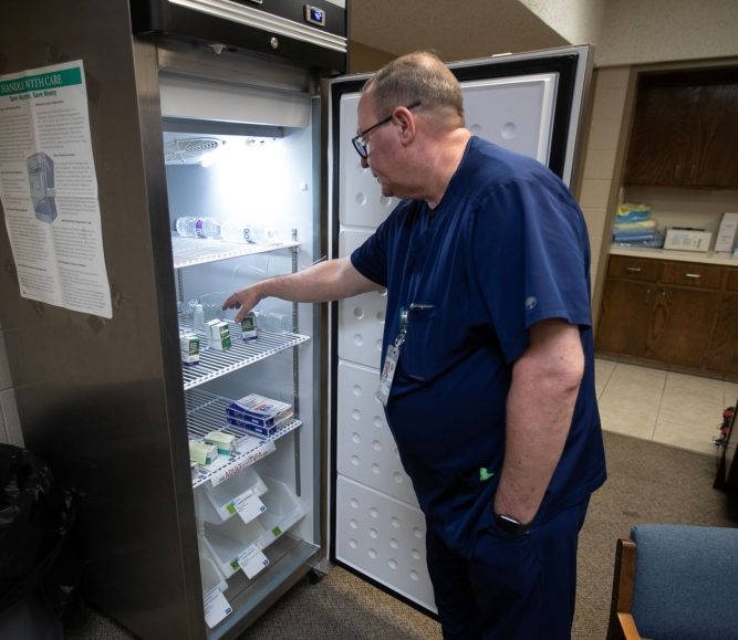 Andrews County Health Department director Gordon Mattimoe looks over the supply of refrigerated measles vaccines at the old City Hall building in Andrews, Texas. Photo by Mark Rogers for The Texas Tribune