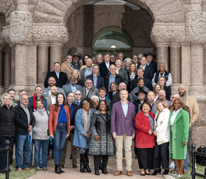 President J.D. Clark (front row, in red jacket), and the NACo Board of Directors pose in front of the Wise County, Texas Courthouse during the 2025 Fall Board Meeting. Photo by Joe Duty