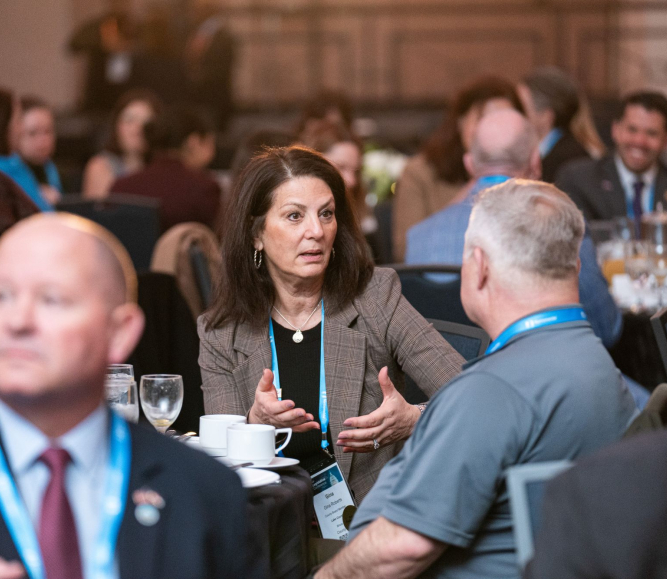 Lake County, Ill. Board Member Gina Roberts engages with fellow county officials Saturday morning at the First-Time Attendees Breakfast at the NACo Legislative Conference. Photo by Denny Henry