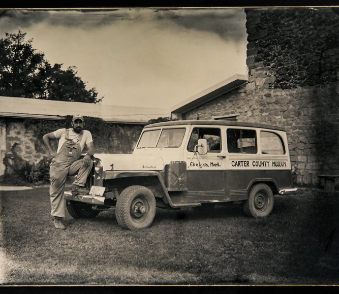 Curator Nathan Carroll poses with the Carter County Museum’s field vehicle, purchased in the 1960s.
