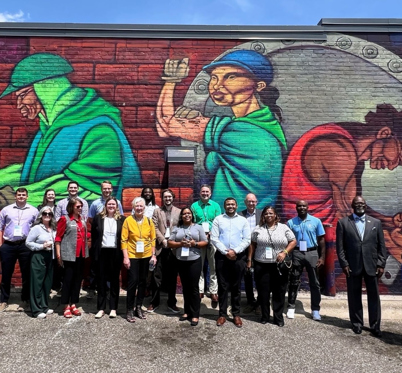 Peer exchange attendees visit a mural during a walking tour of Ramsey County, Minn.