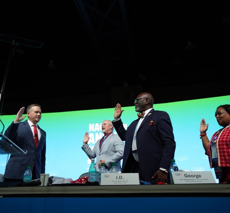 NACo President JD Clark swears in Immediate Past President James Gore, First Vice President George Dunlap and Second Vice President Alisha Bell. Photo by Denny Henry