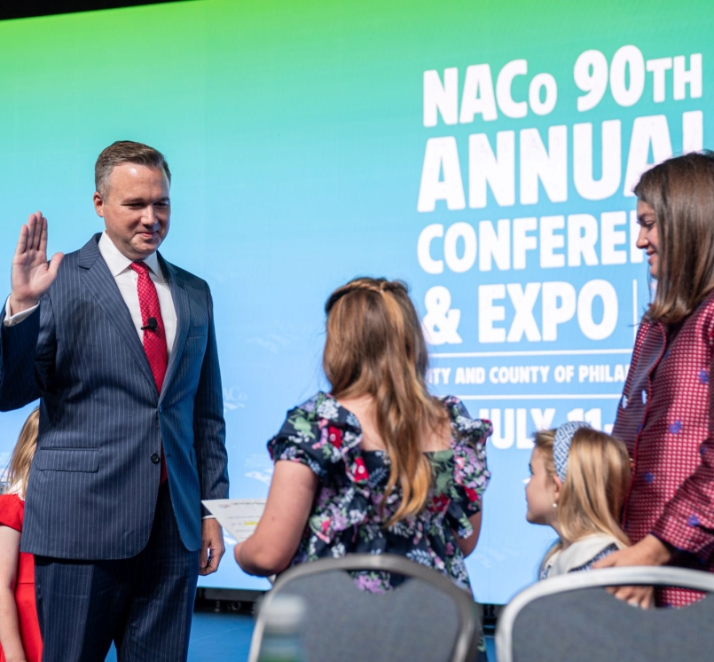 J.D. Clark takes the oath of office, administered by his daughter, Claire, at the 2025 Annual Conference. Photo by Denny Henry