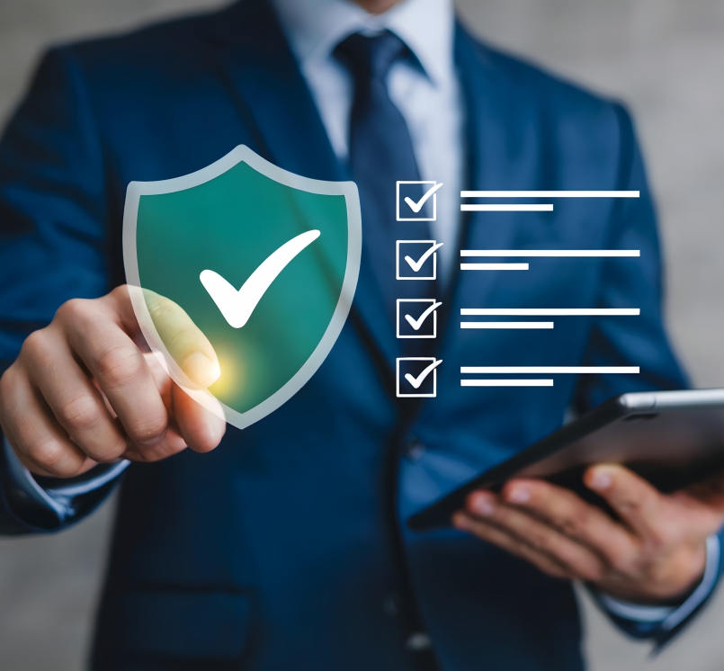 man pointing at a cybersecurity shield with a checkmark and then a checklist is next to it