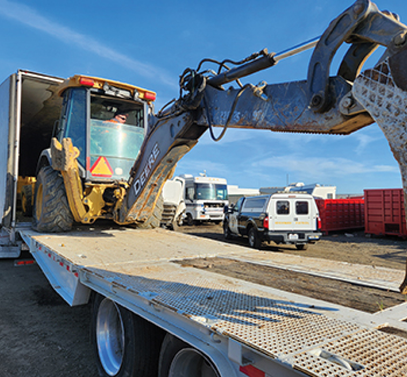 A stolen backhoe being unloaded in March 2024 from a semitruck, recovered by law enforcement in Tulare County, Calif. Photo courtesy of the Tulare County Sheriff’s Office