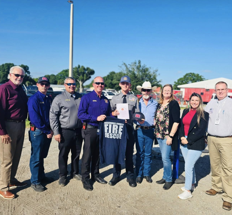 After completing the Okeechobee High School CTE Fire Program, Braxton Lewis (pictured in the middle) was offered a job with Fire Rescue. Photo courtsey of Okeechobee County