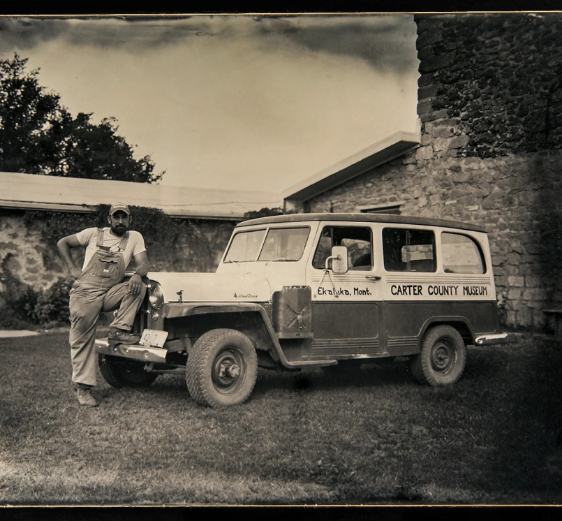 Curator Nathan Carroll poses with the Carter County Museum’s field vehicle, purchased in the 1960s.