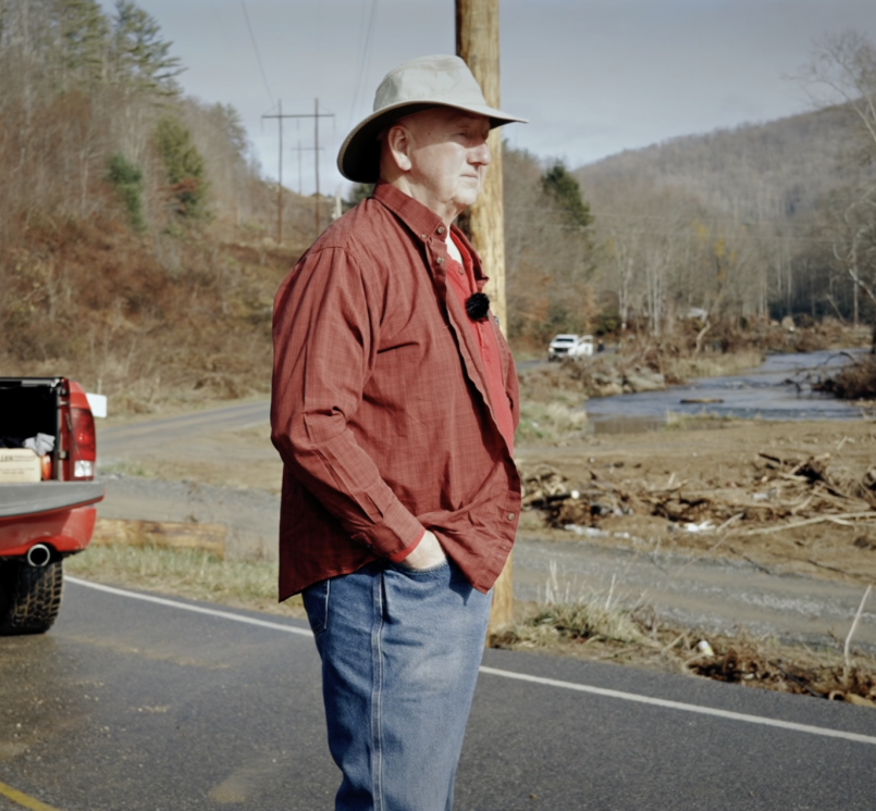 Avery County, N.C. Commissioner Dennis Aldridge surveys damage from Hurricane Helene in 2024 in this still from the North Carolina Association of County Commissioners’ documentary, “Rising Above Helene,” directed by Chris Baucom of 100 Strong Productions. 