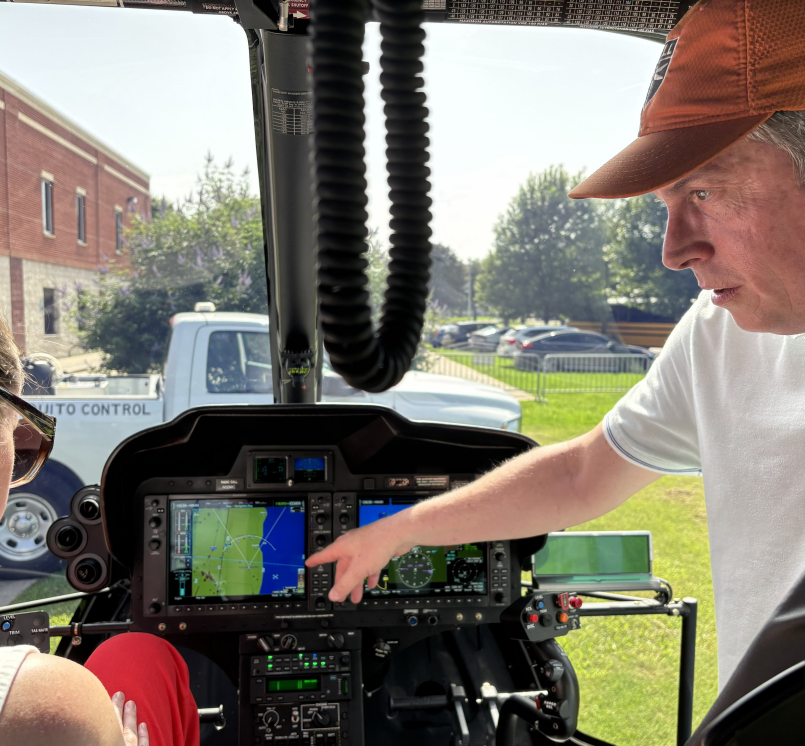 Aviation Supervisor Jeff Fletcher shows Wayne County, Mich. Commissioner Melissa Daub how the New Orleans Mosquito, Termite and Rodent Control Board's helicopter sprays for both mosquito adults and larvae.  Photo by Charlie Ban