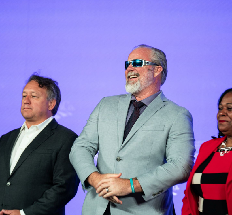 Flanked by West Region Representative Bill Novotny and First Vice President Alisha Bell, former NACo President James Gore takes in the spotlight at the 2026 Annual Conference. Photo by Denny Henry
