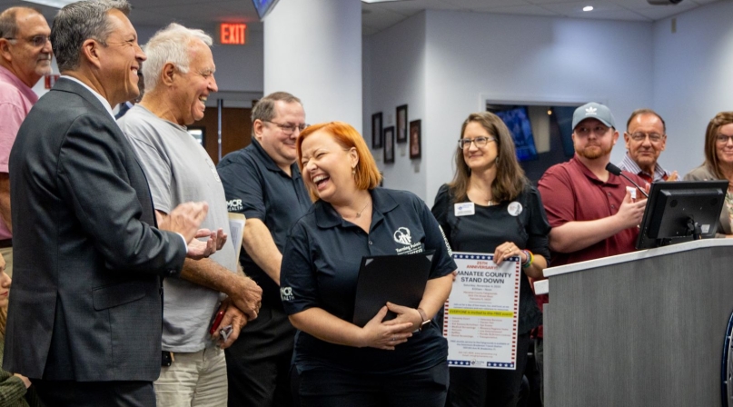 Kathleen Cramer (center) celebrates a county resolution honoring Manatee County Stand Down. Photo courtesy of Manatee County