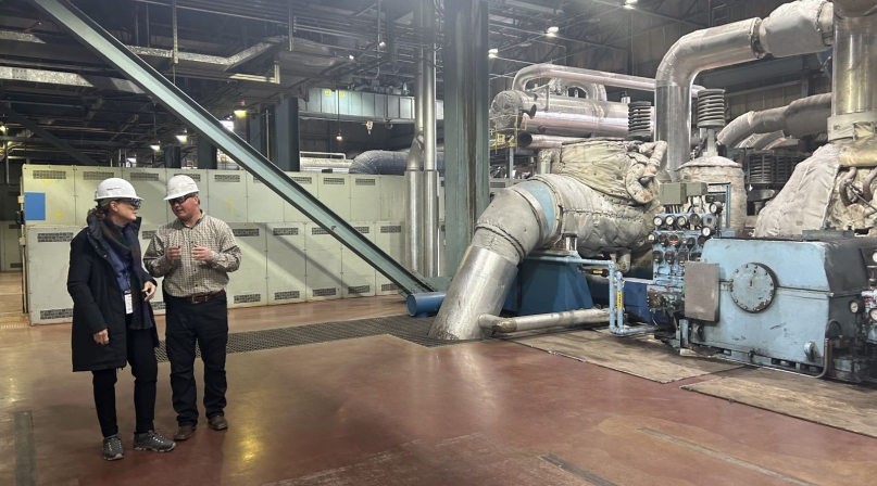 Cindy Winland, senior consultant, Interagency Working Group for Energy Communities, talks with an engineer at Naughton Power Plant in Lincoln County, Wyo.